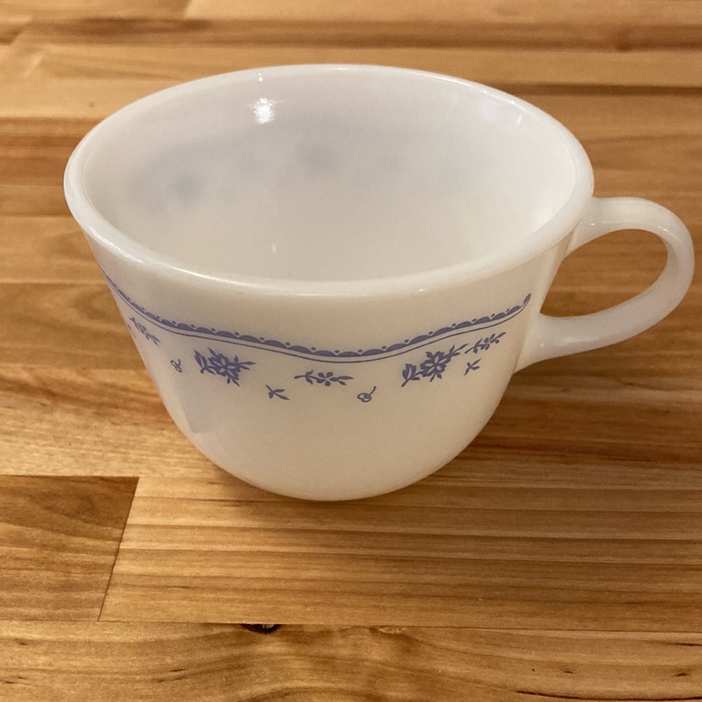 Two Pyrex mugs, white with floral band pattern.